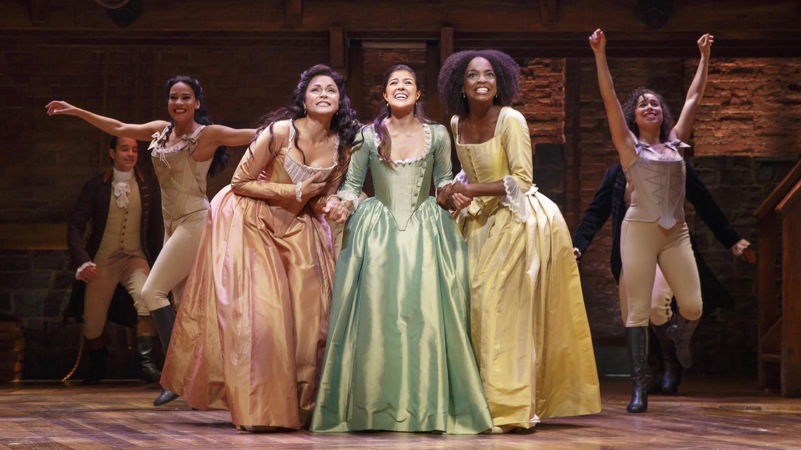 The cast of Hamilton, the Broadway musical, perform on stage. - Hamilton