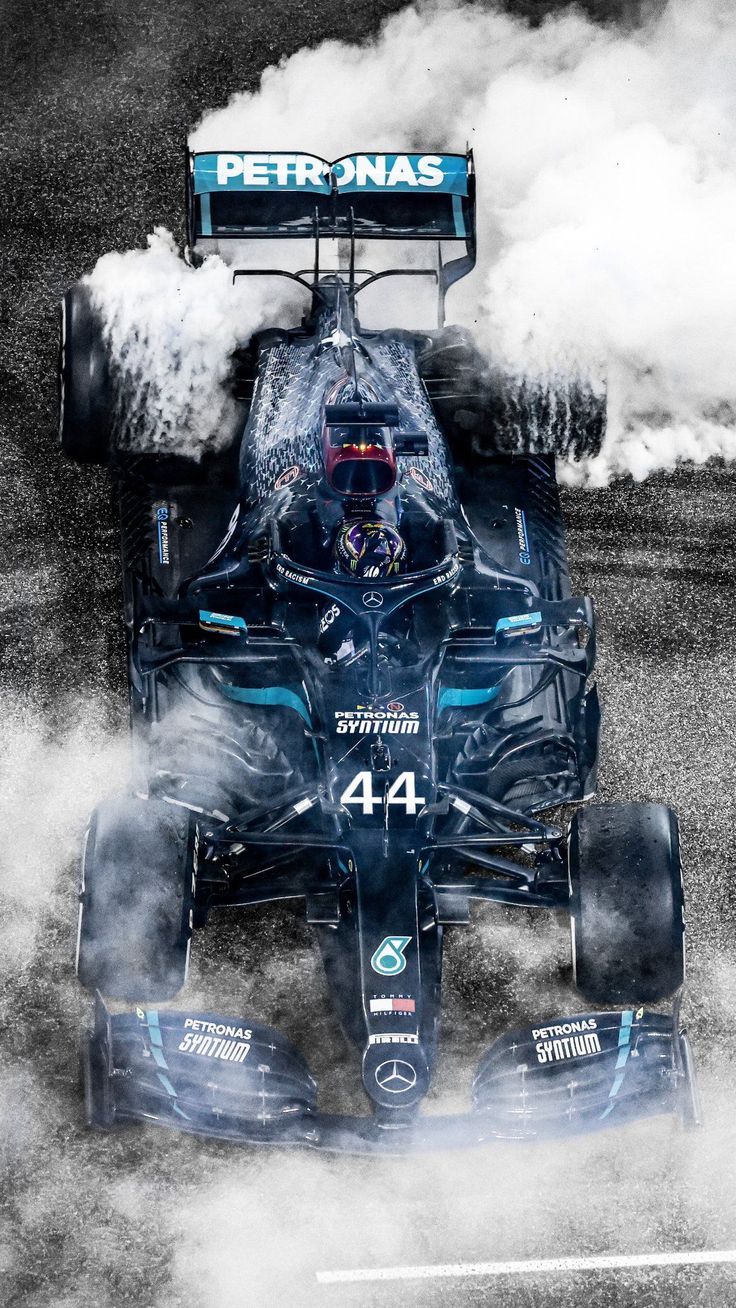 Lewis Hamilton driving a car with smoke coming out of it - Lewis Hamilton