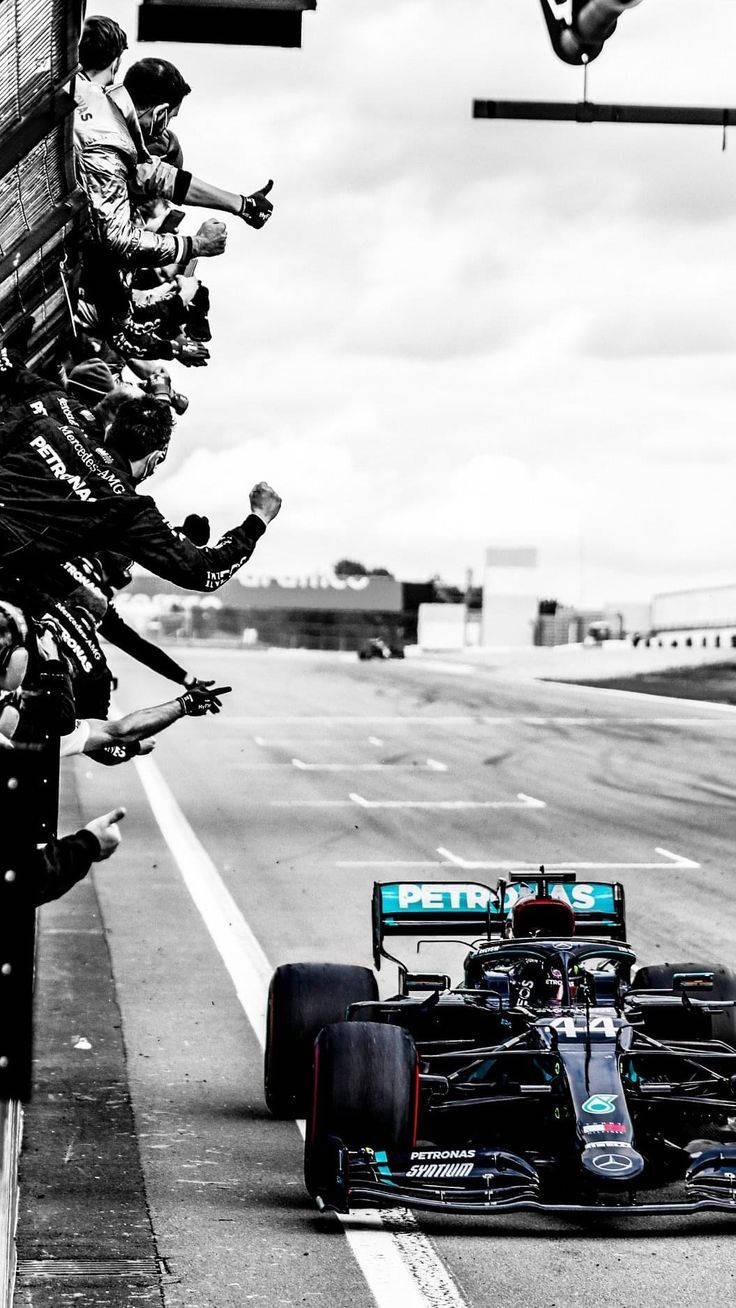 Mercedes-AMG Petronas Motorsport's Lewis Hamilton celebrates with his team after winning the 2020 Formula 1 British Grand Prix at Silverstone. - Lewis Hamilton