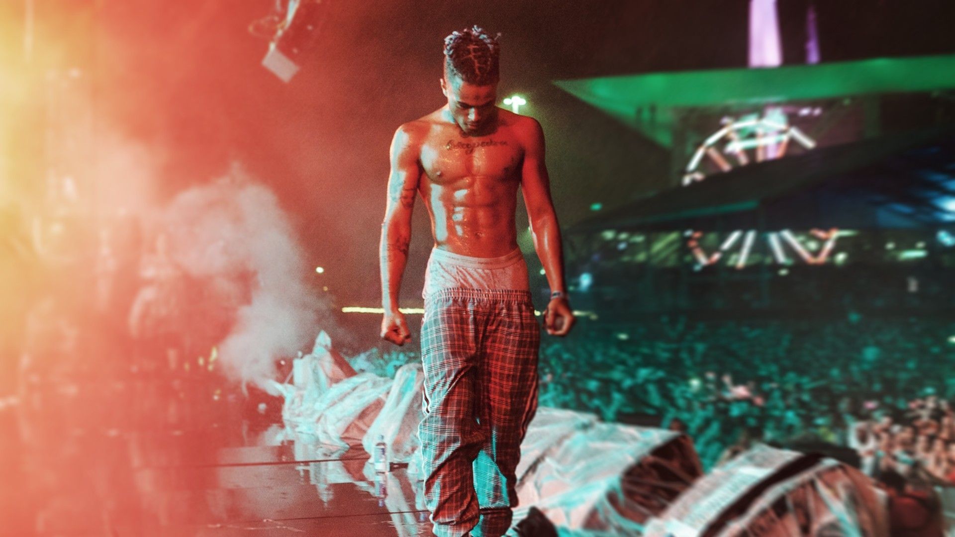 A man standing on stage with no shirt - XXXTentacion