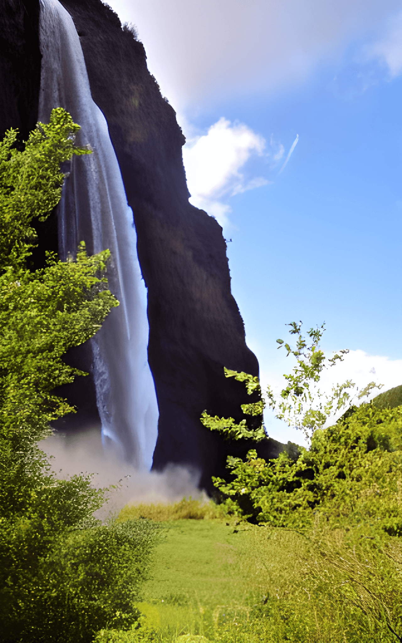 A waterfall with a rainbow in the mist. - Waterfall