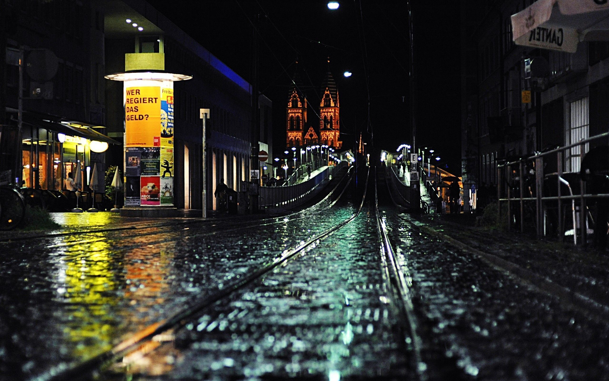 A wet street with train tracks at night. - 2560x1600, night