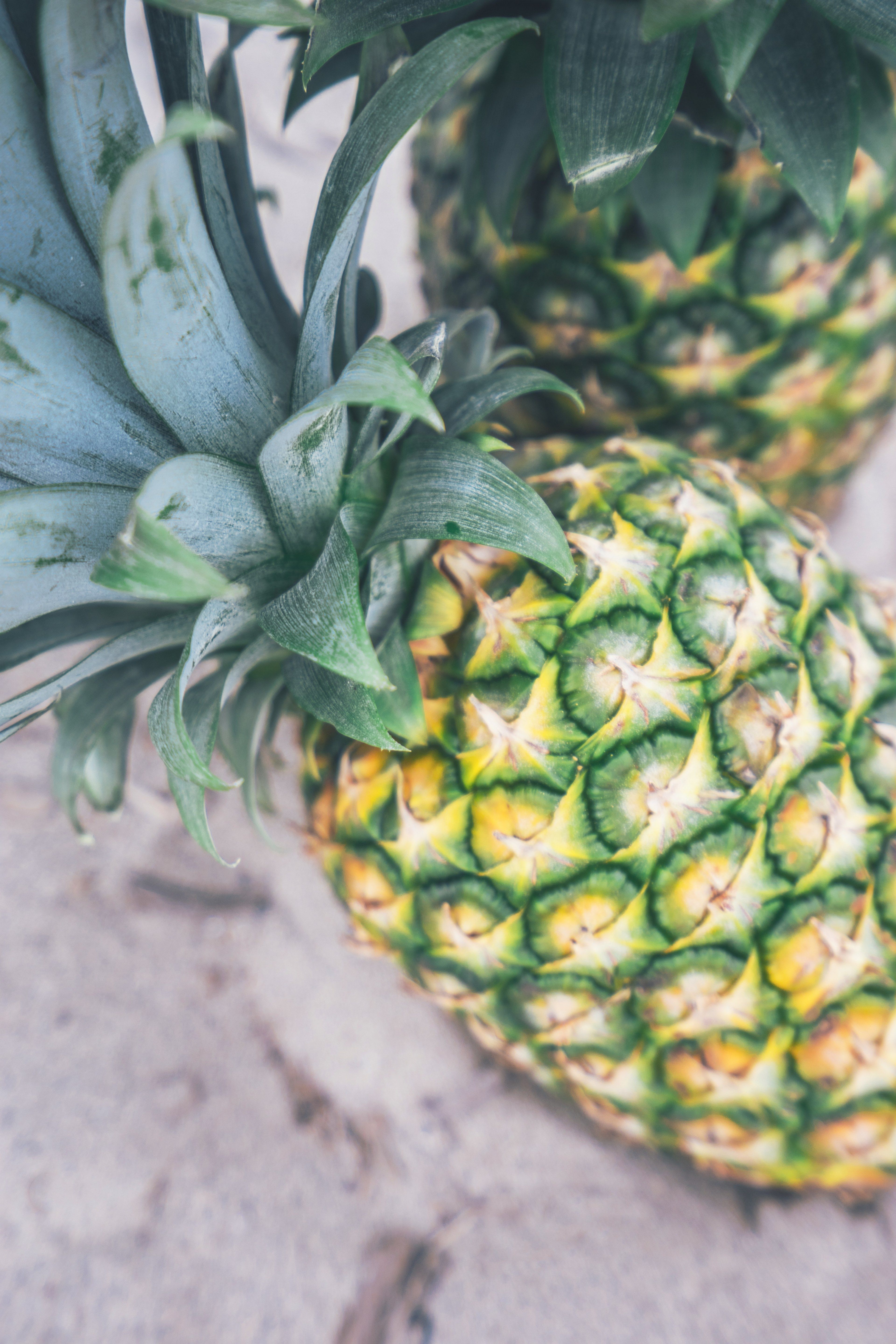 Wallpaper / fresh pineapple on a market sidewalk, couple of pineapples 4k wallpaper free download