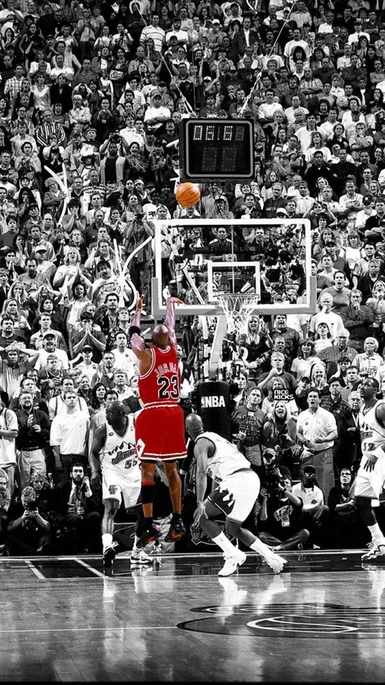 The image shows Michael Jordan making a game-winning shot in front of a large crowd. - Michael Jordan