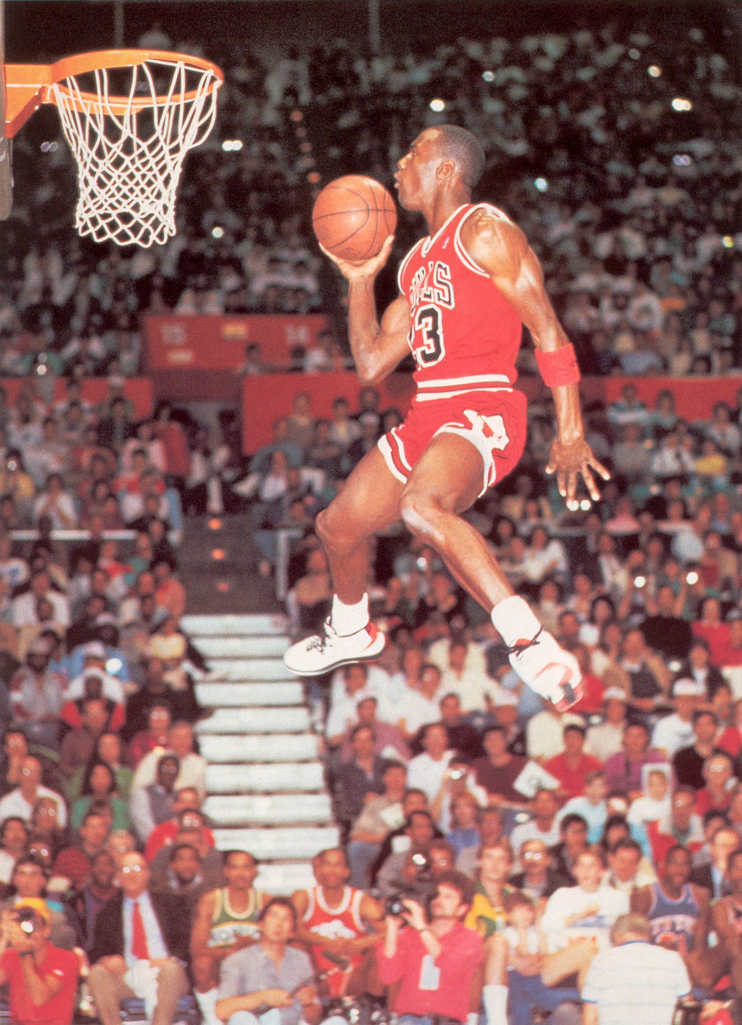 Michael Jordan, in his iconic 1984 Air Jordan shoes, soars above the rim during the 1986 NBA Slam Dunk contest. - Michael Jordan