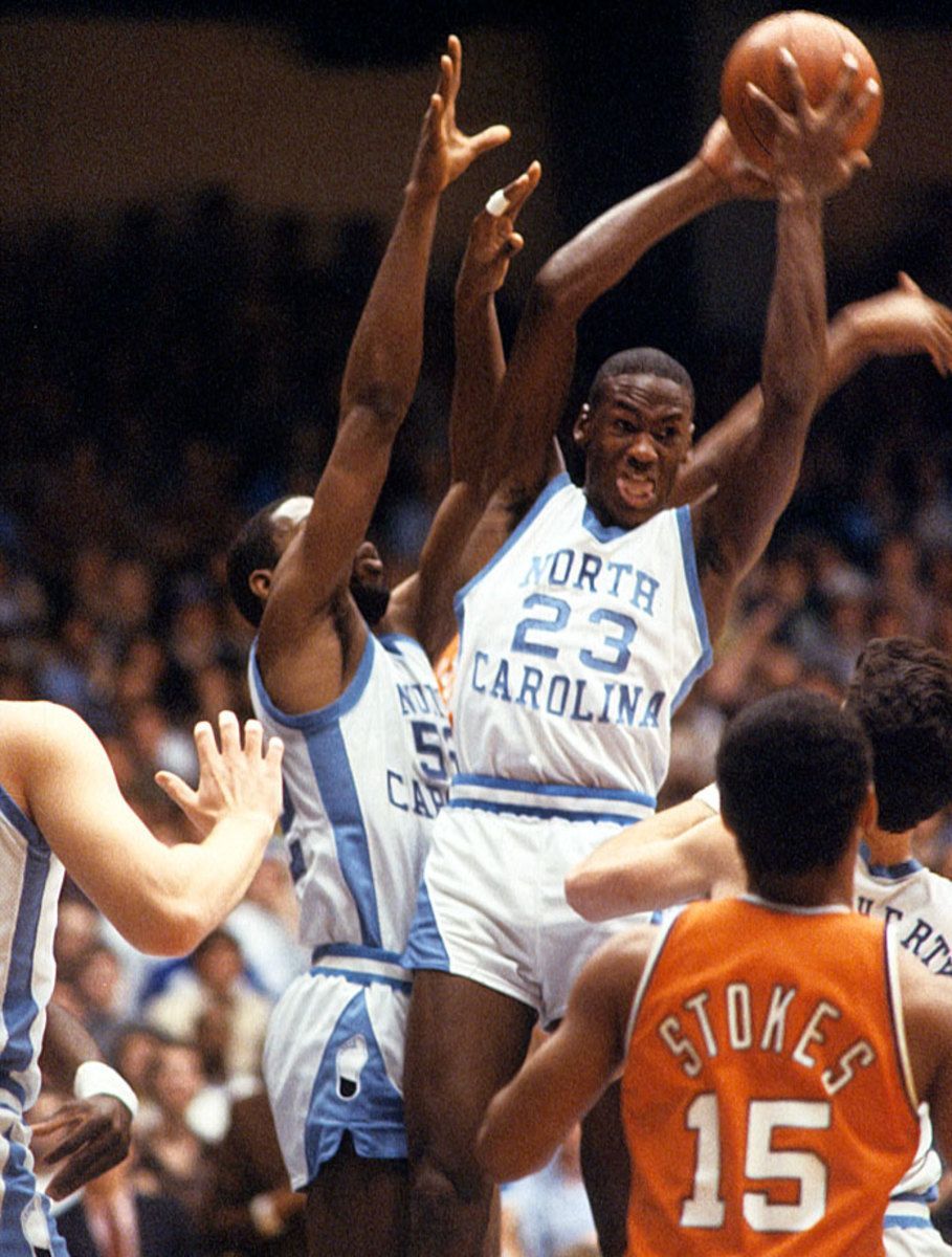 North Carolina's Michael Jordan (23) goes up for a shot against Virginia Tech's Robert Brown (50) and Alonzo Barfield (15) during a game in 1982. - Michael Jordan