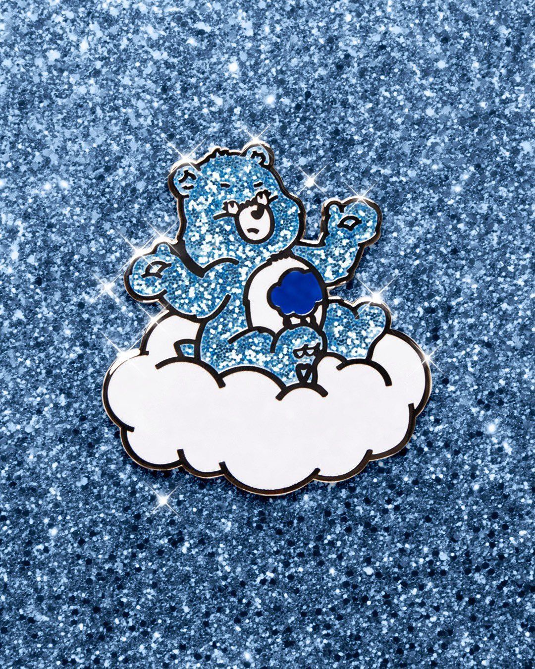 A Care Bears pin with a blue bear sitting on a cloud - Care Bears