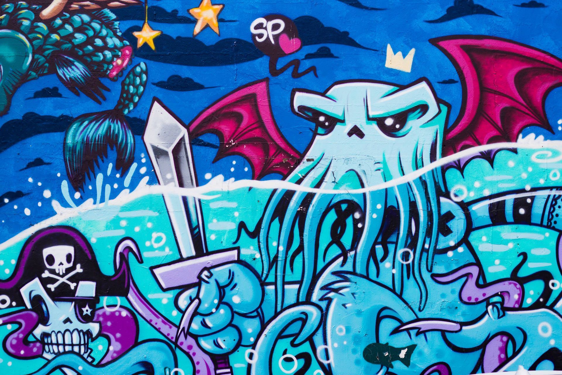 A wall with a painting of a blue octopus holding a sword in front of a red bat. - Graffiti