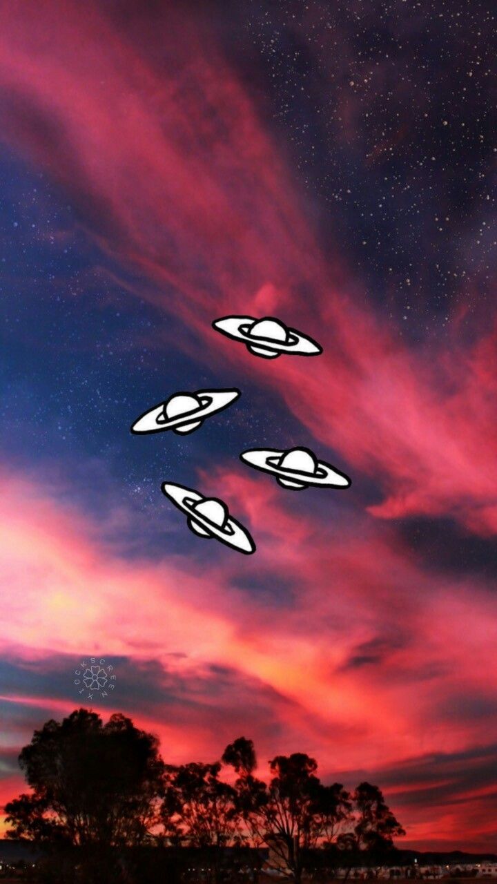 Four white spaceships fly through a pink and blue sky - Alien