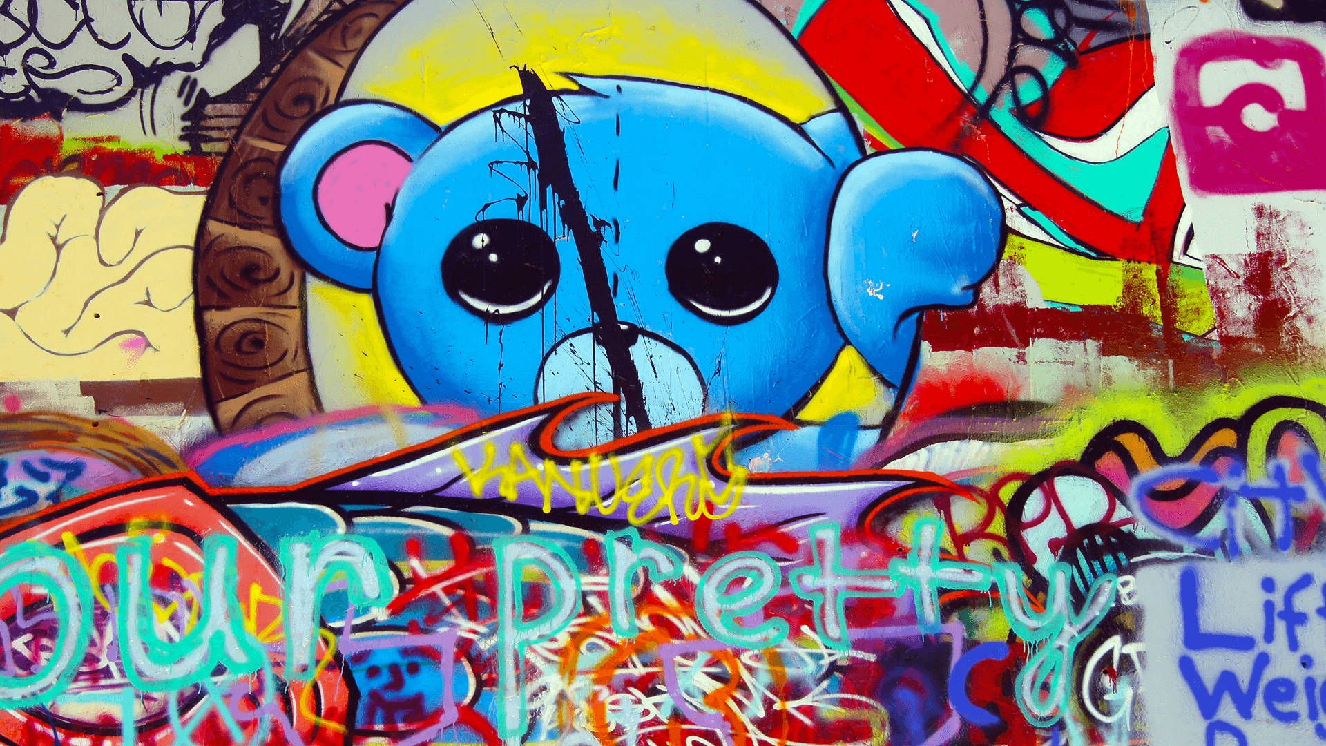 A colorful graffiti wallpaper with a blue teddy bear - Graffiti