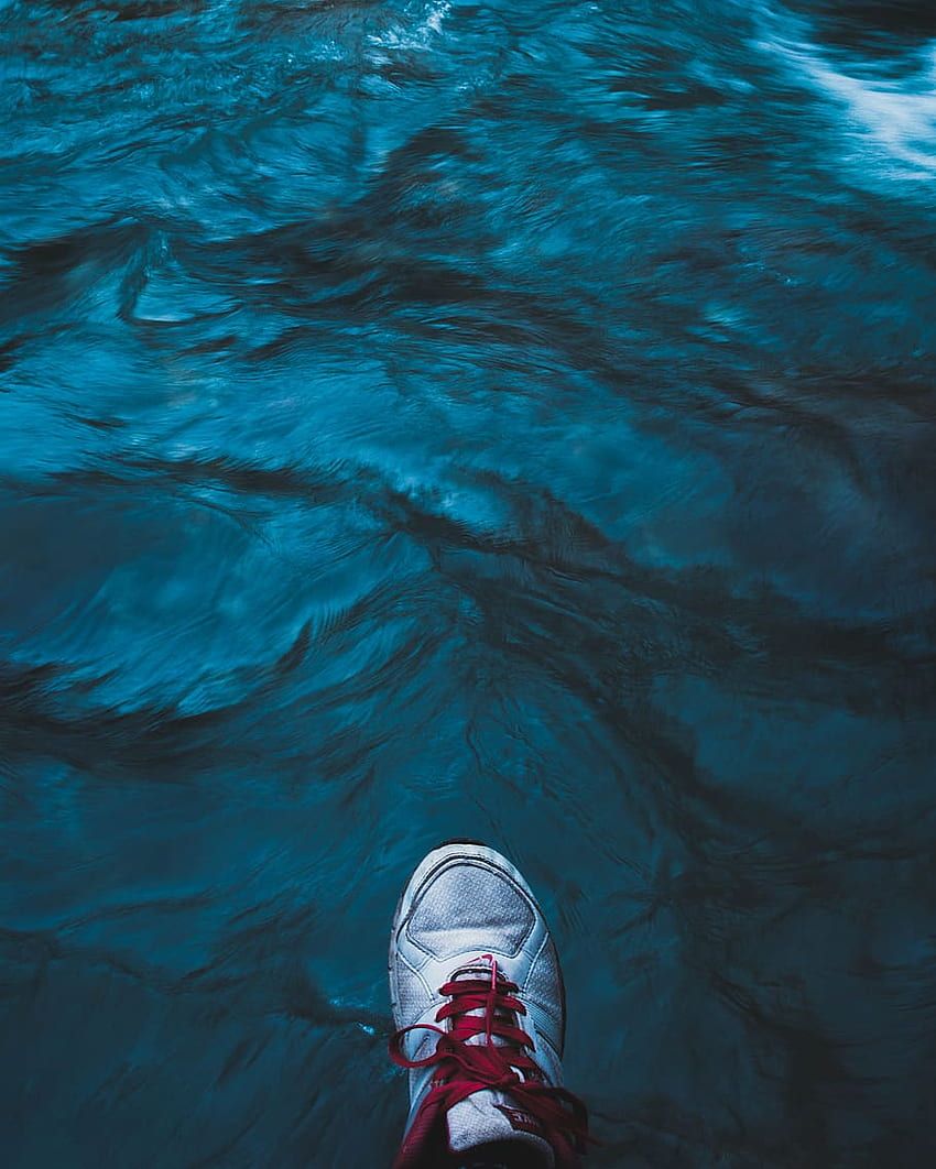 A person standing on top of water - River