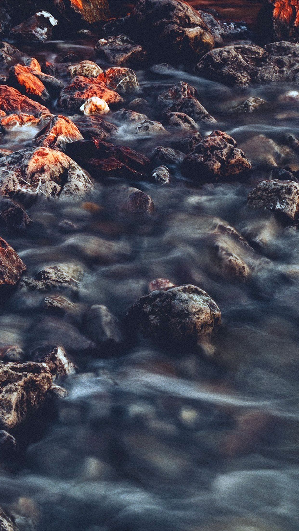 A river flows over rocks in this iPhone wallpaper. - River