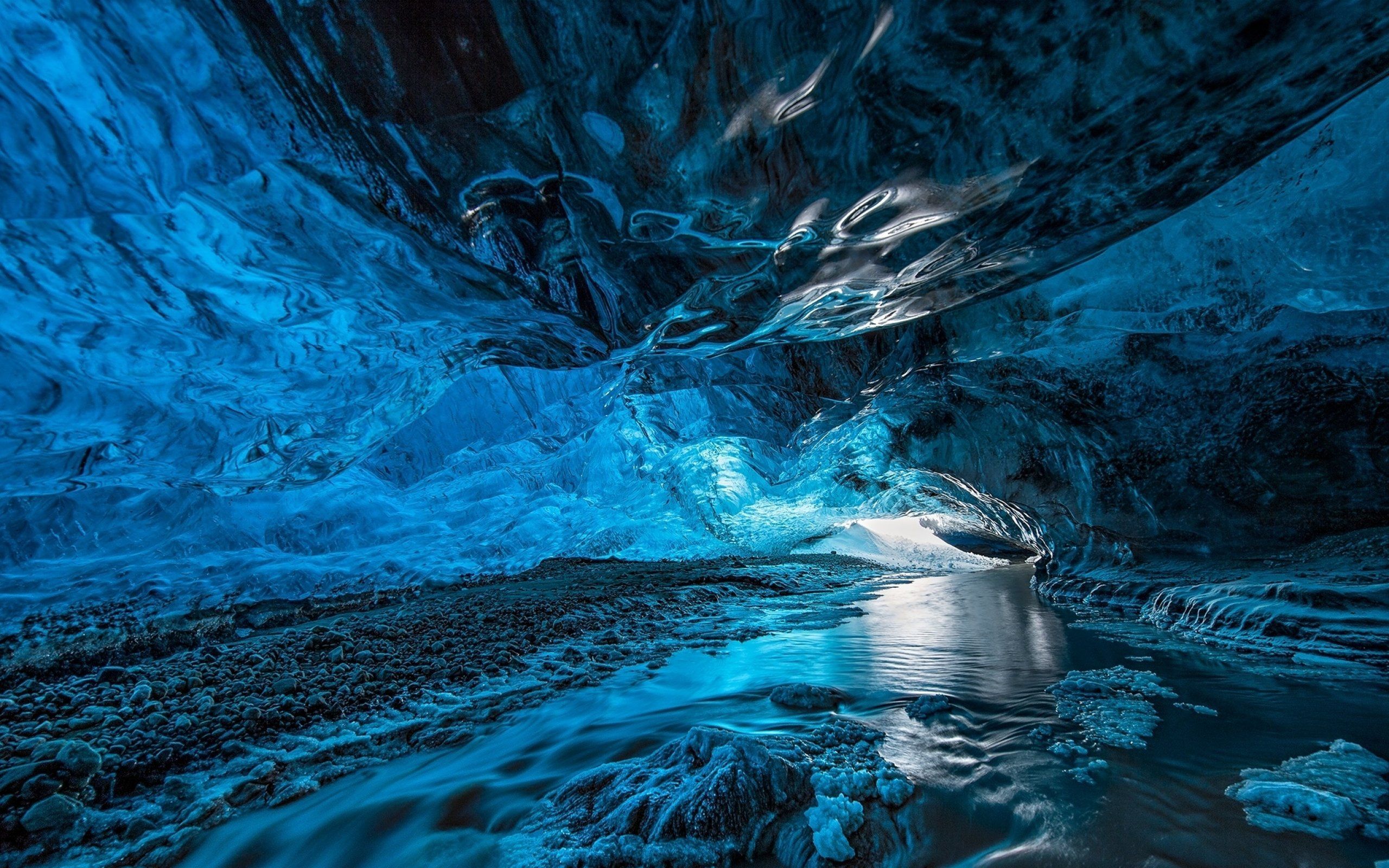 A blue cave with water flowing through it - Ice