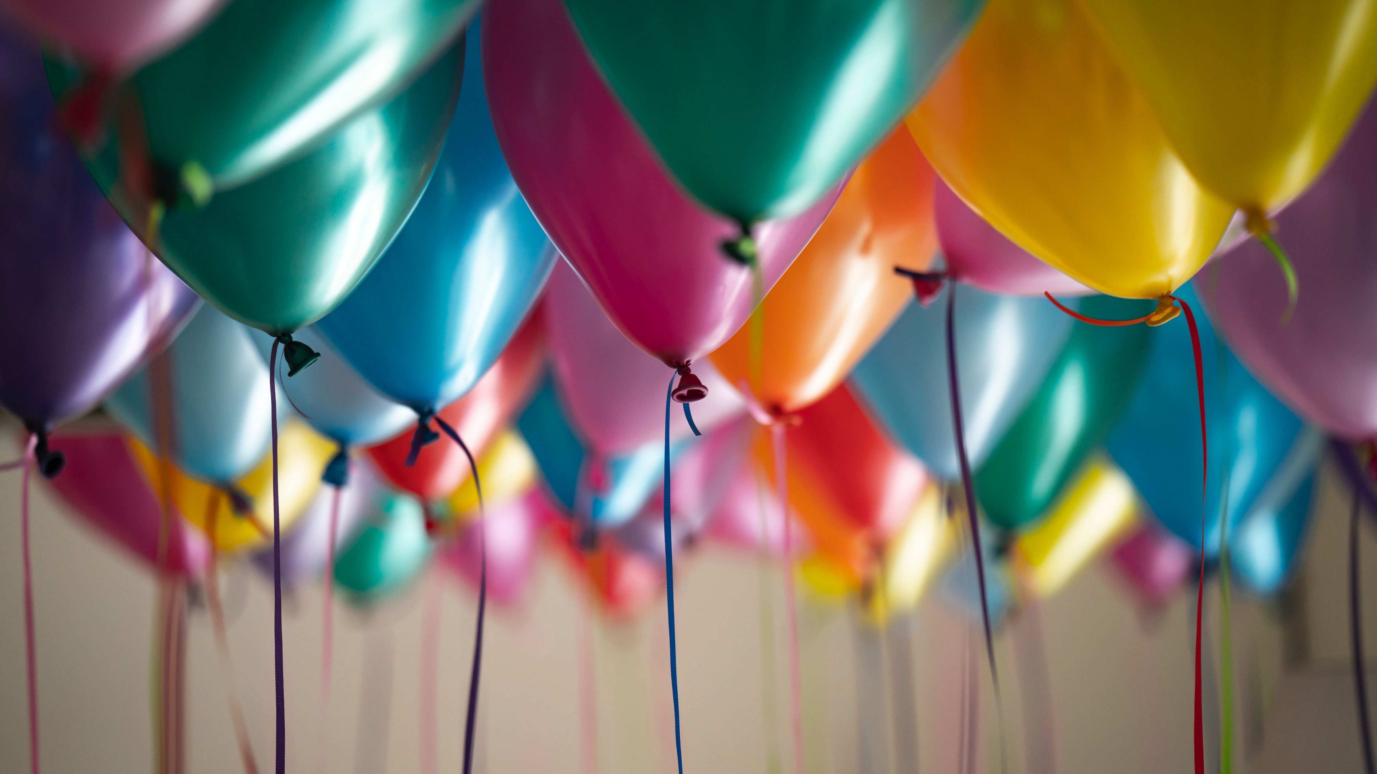 A group of colorful balloons floating in the air. - Balloons, birthday