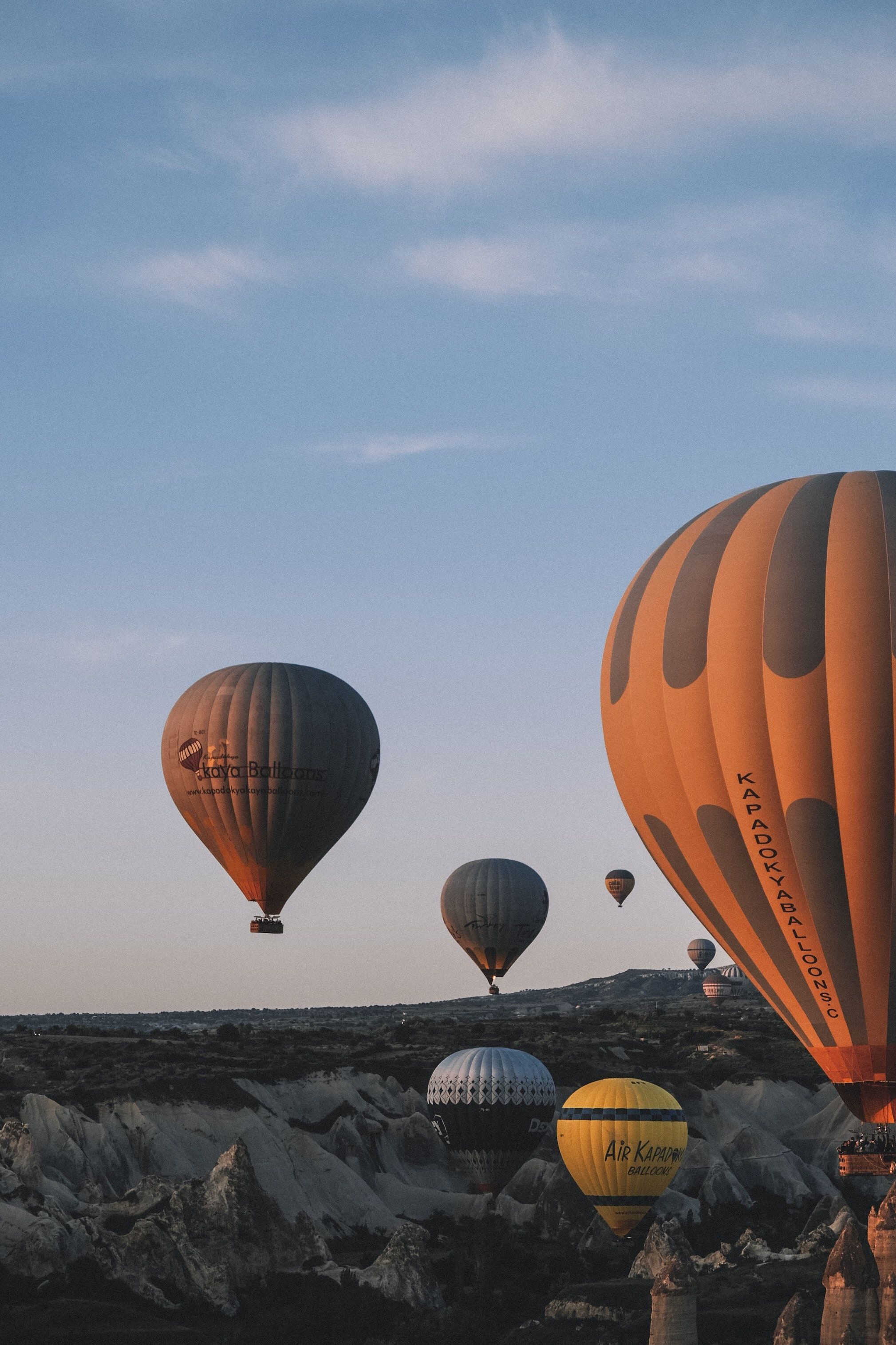 Hot air balloons floating over a rocky landscape - Hot air balloons