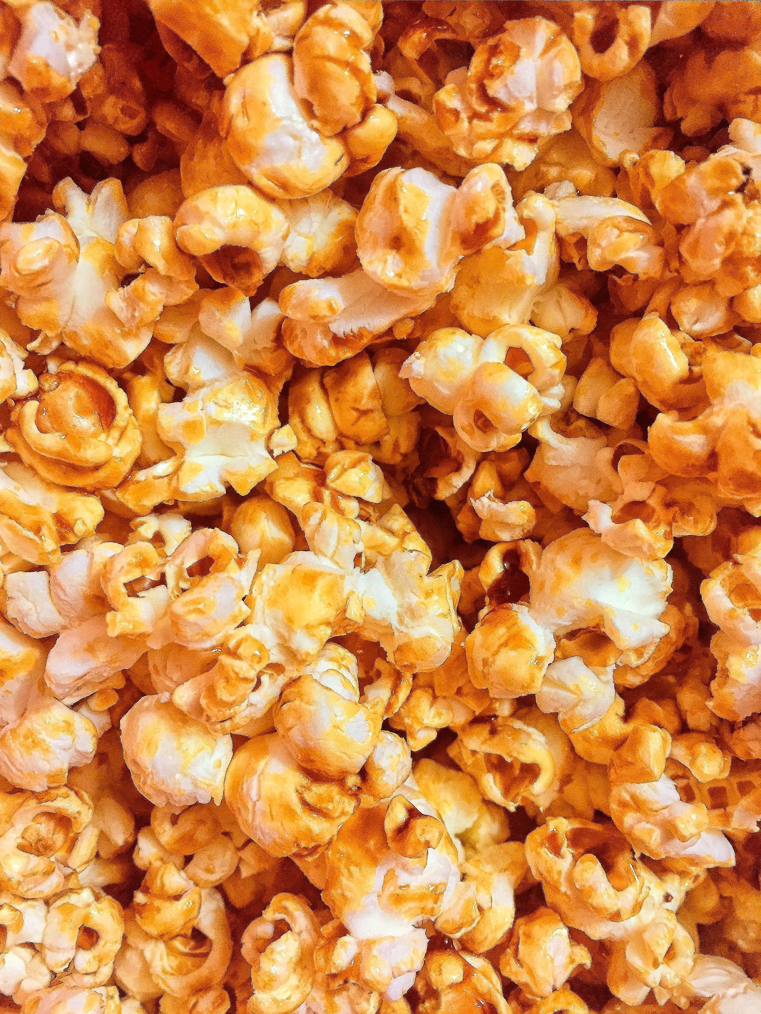 A close up of a pile of caramel popcorn - Popcorn