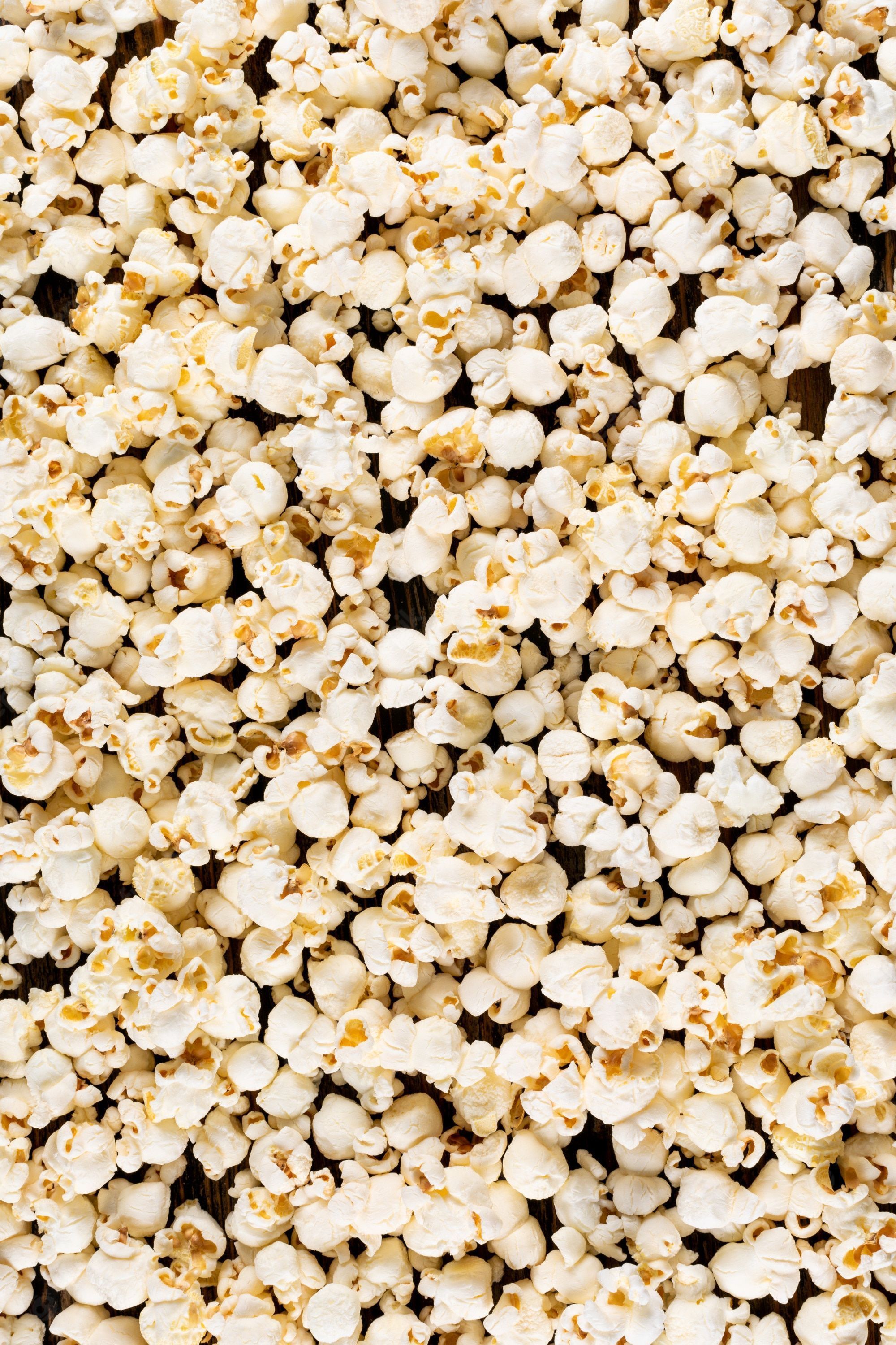 A close up of popcorn on a wooden table - Popcorn