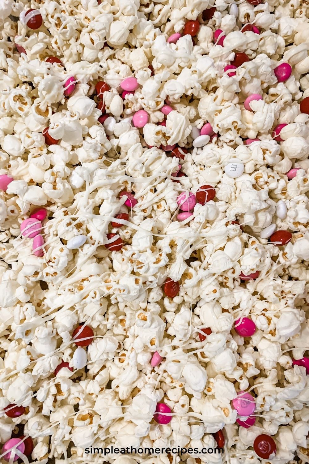 Valentine's Day Popcorn with M&M's and white chocolate drizzled on top. - Popcorn