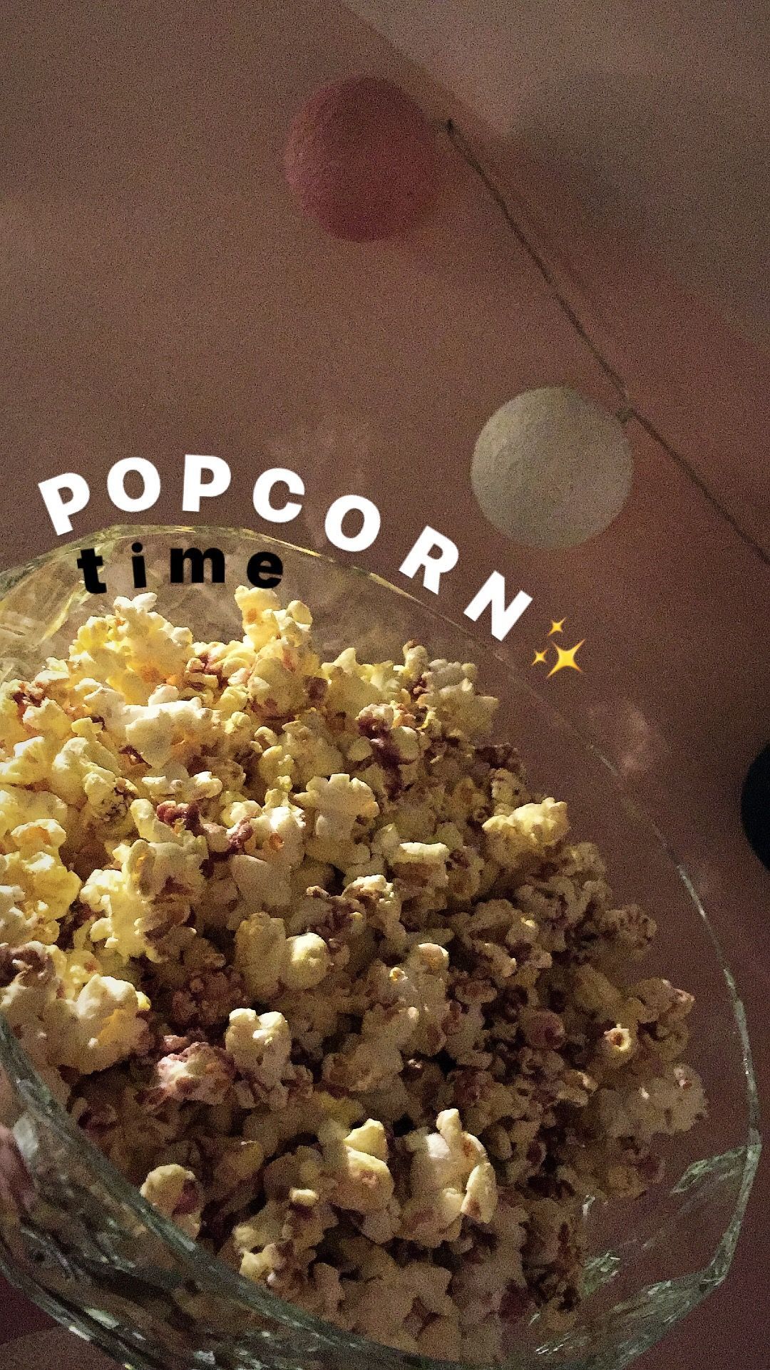 A bowl of popcorn sits on a table with the words popcorn time written above it. - Popcorn