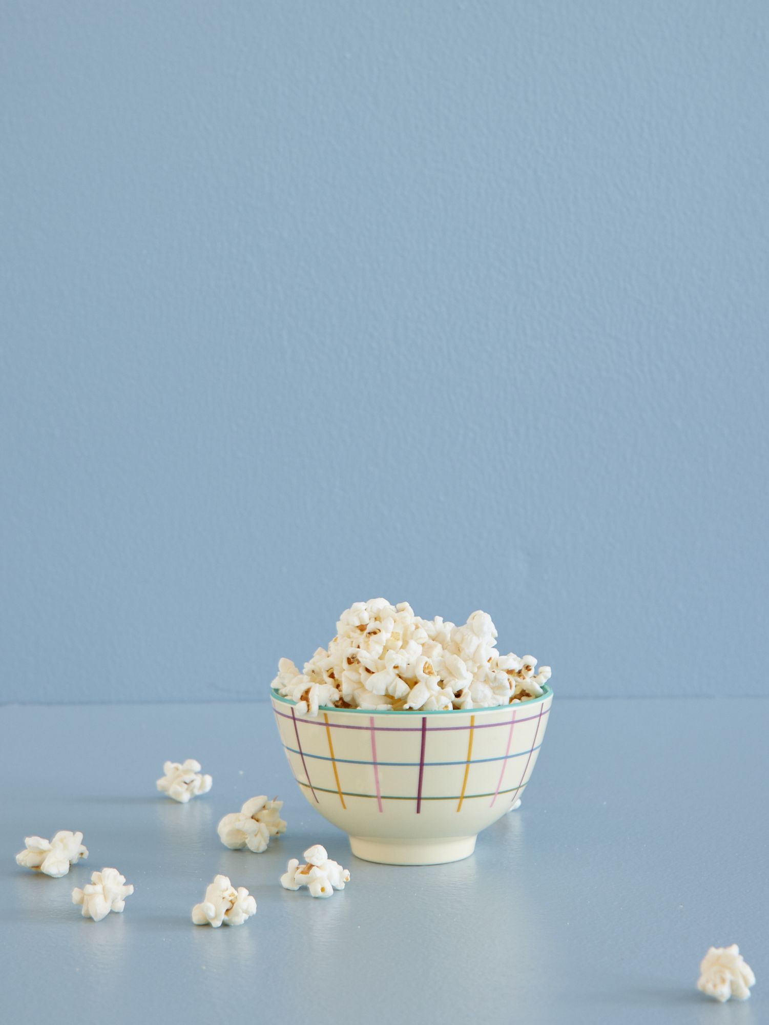 Popcorn in a bowl on a blue background - Popcorn