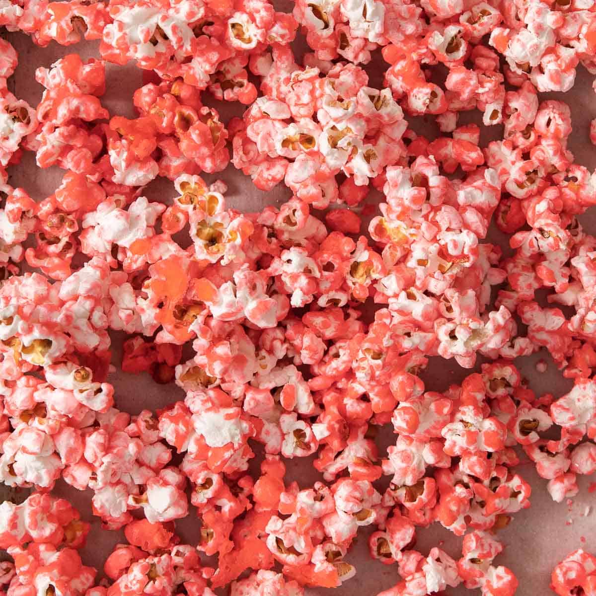 Close up of pink popcorn on a baking sheet. - Popcorn