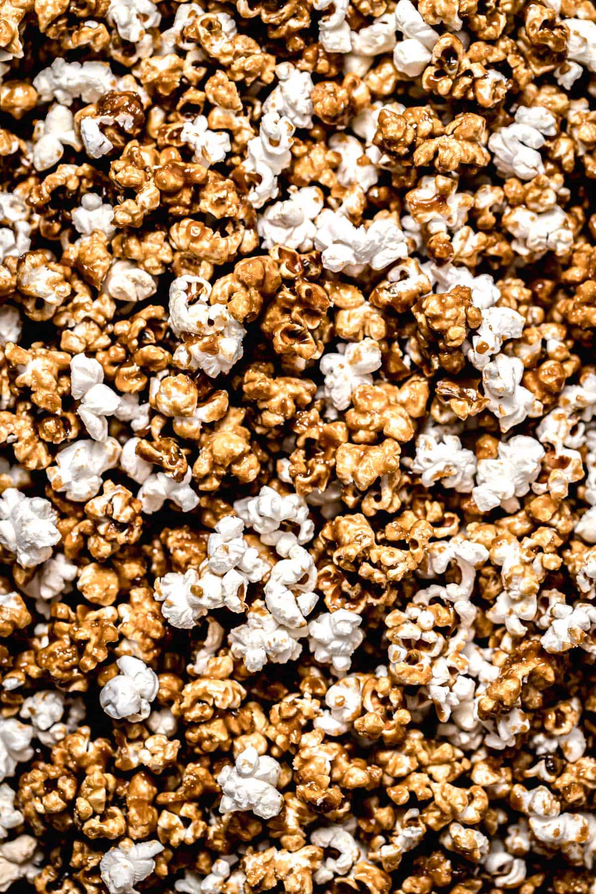 A close up of homemade salted caramel popcorn on a table. - Popcorn