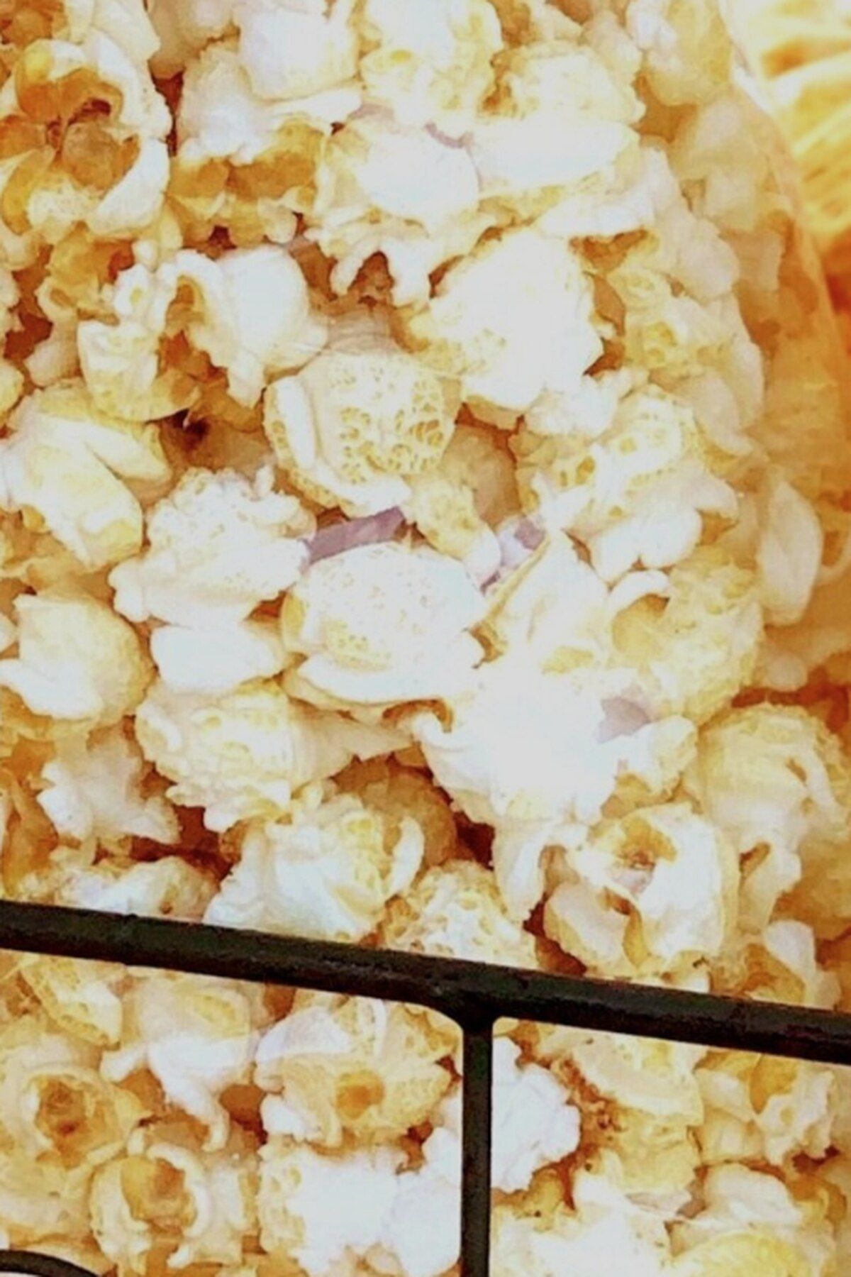 A close up of a pile of popcorn on a shelf. - Popcorn