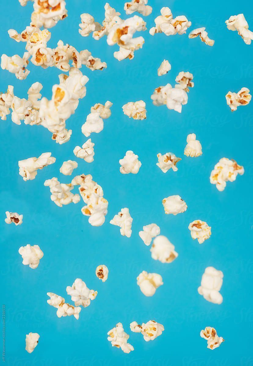 Popcorn falling on a blue background - Popcorn