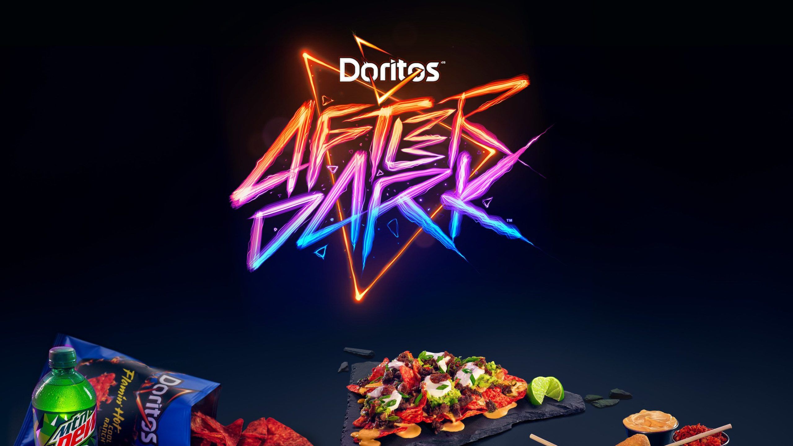 A neon sign for Doritos After Dark with a plate of nachos in the foreground. - Doritos