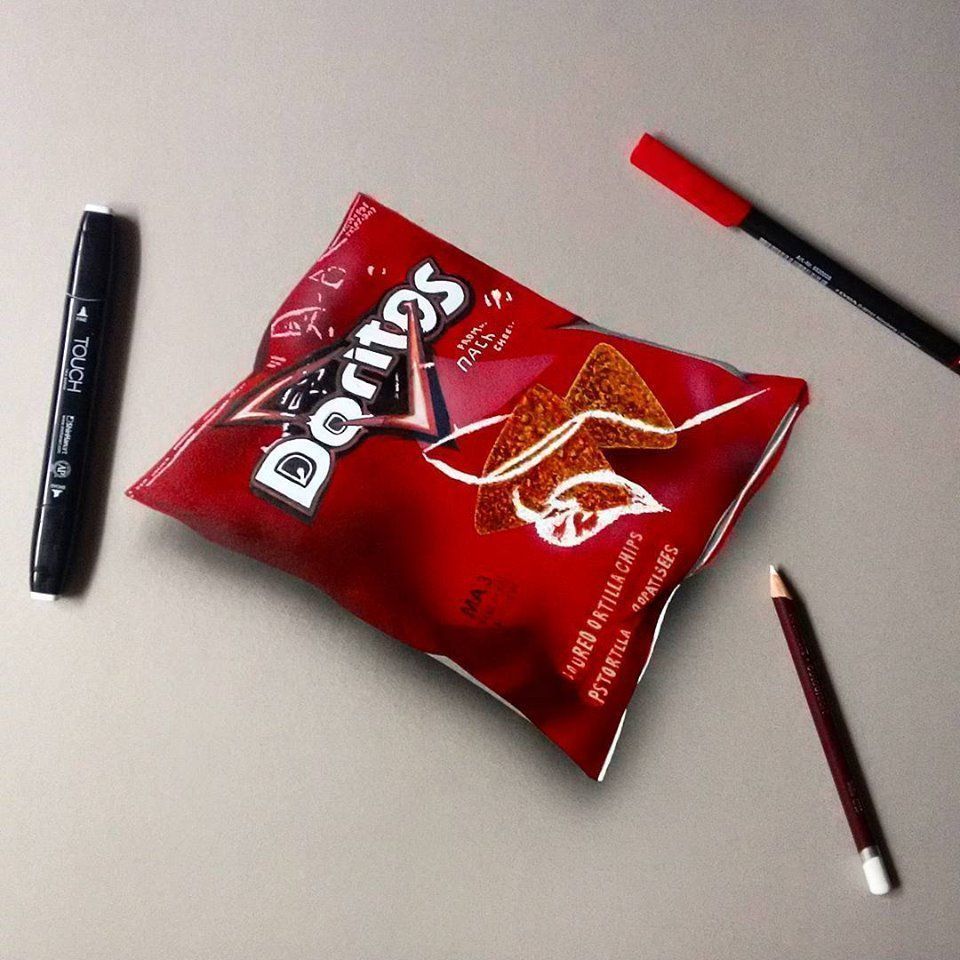 A bag of Doritos next to a red pen and a pencil - Doritos