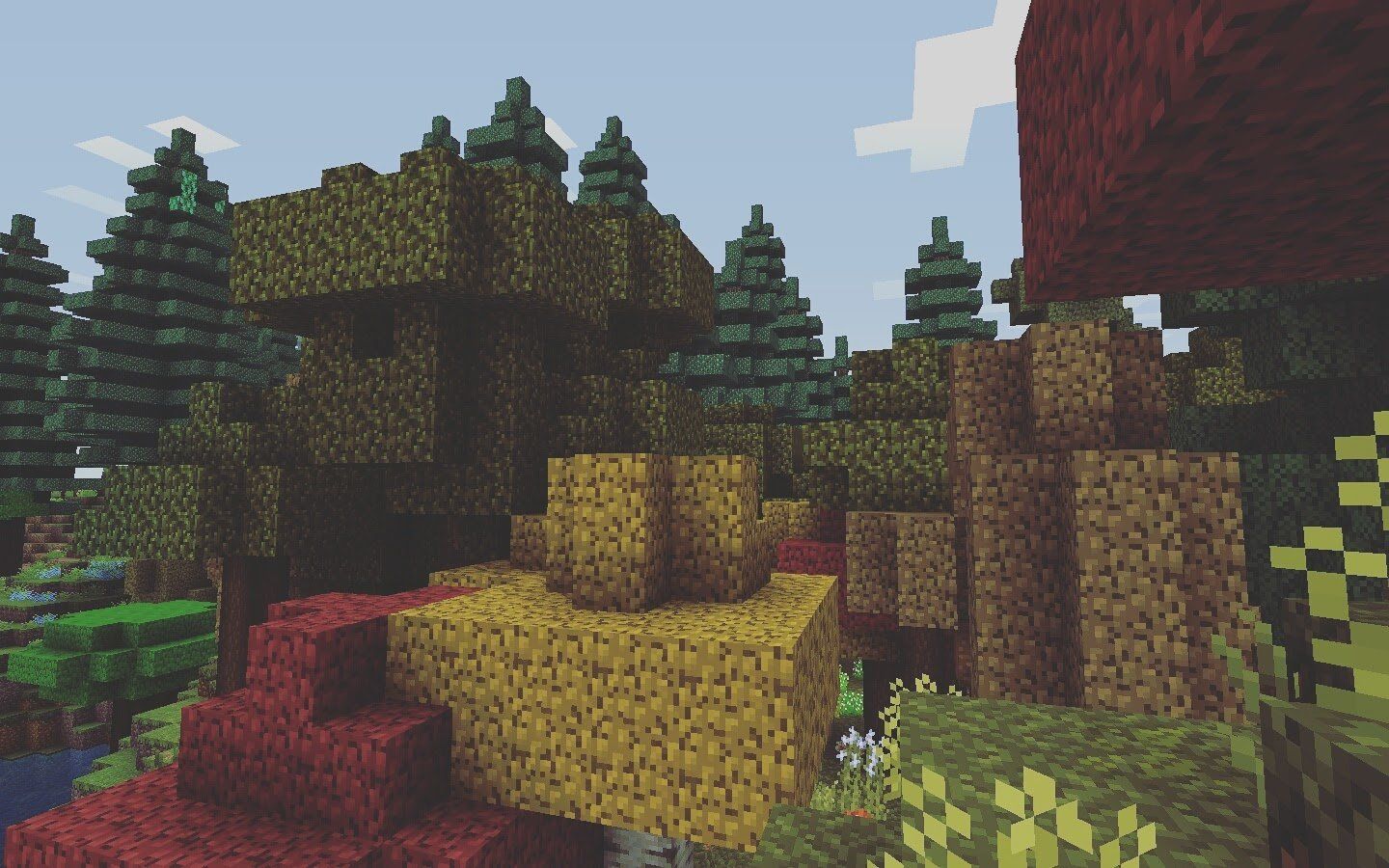 A screenshot of a Minecraft forest, with a tall tree in the middle and a small waterfall - 1440x900