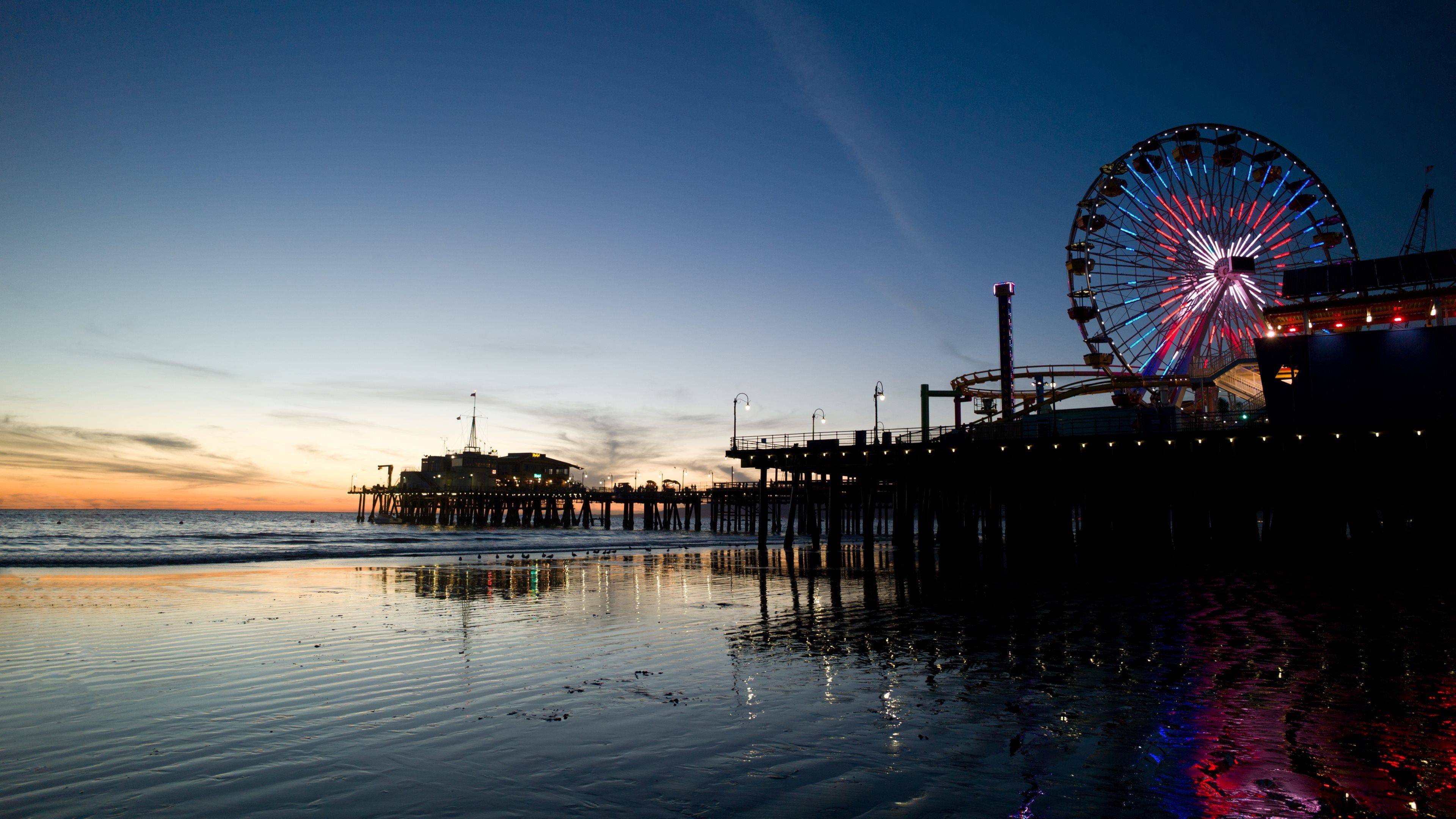 A Ferris wheel and a pier at sunset. - Los Angeles