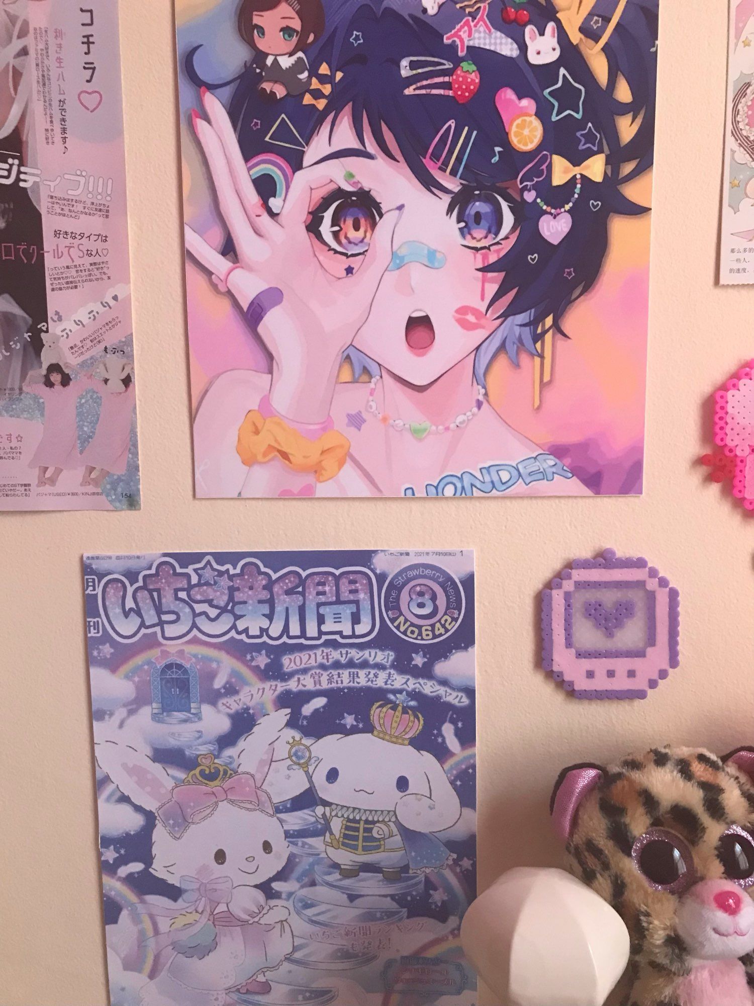 A wall with posters of anime characters and stickers. - Animecore