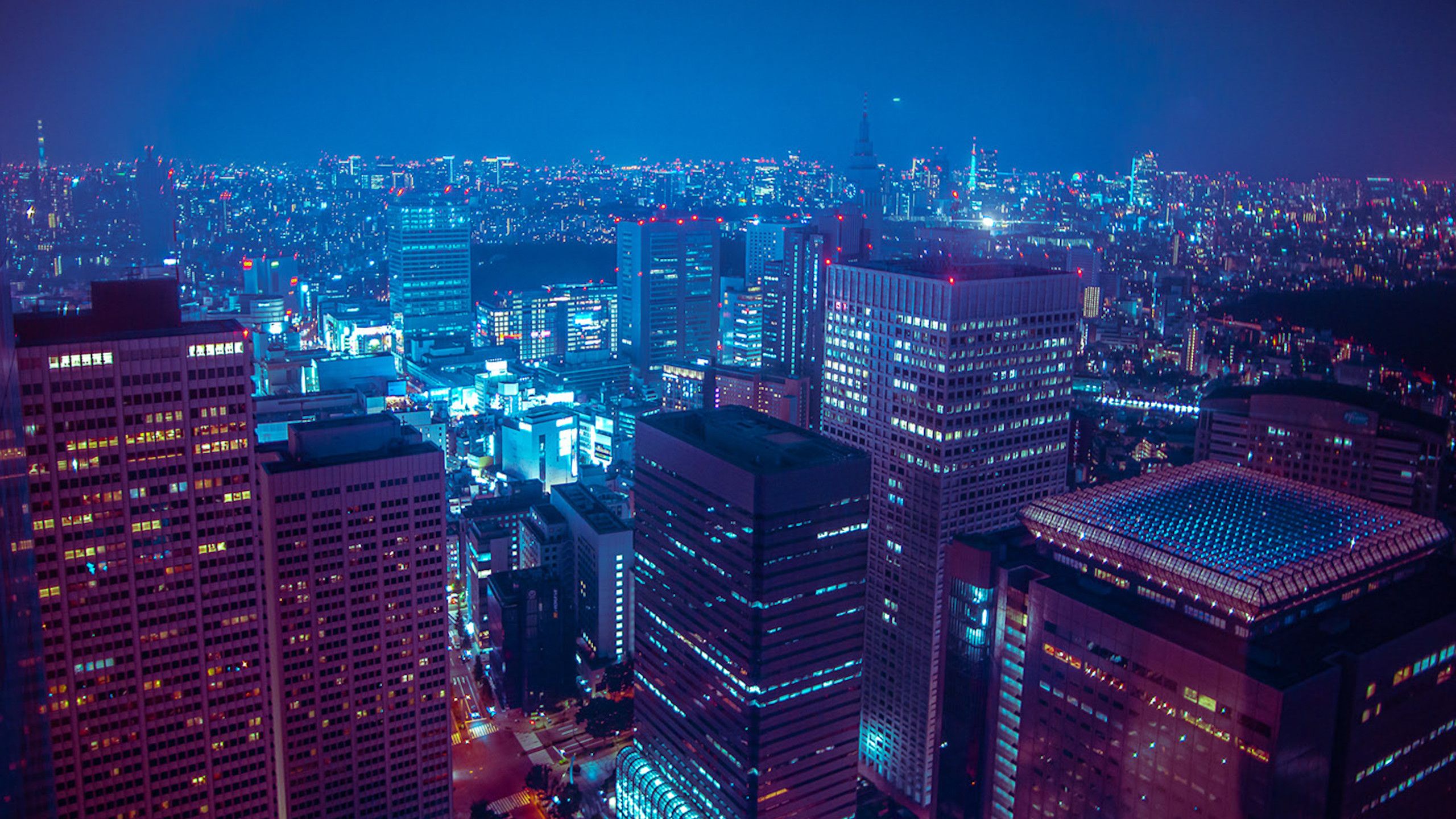 A cityscape at night with blue and purple hues - Neon, Japan