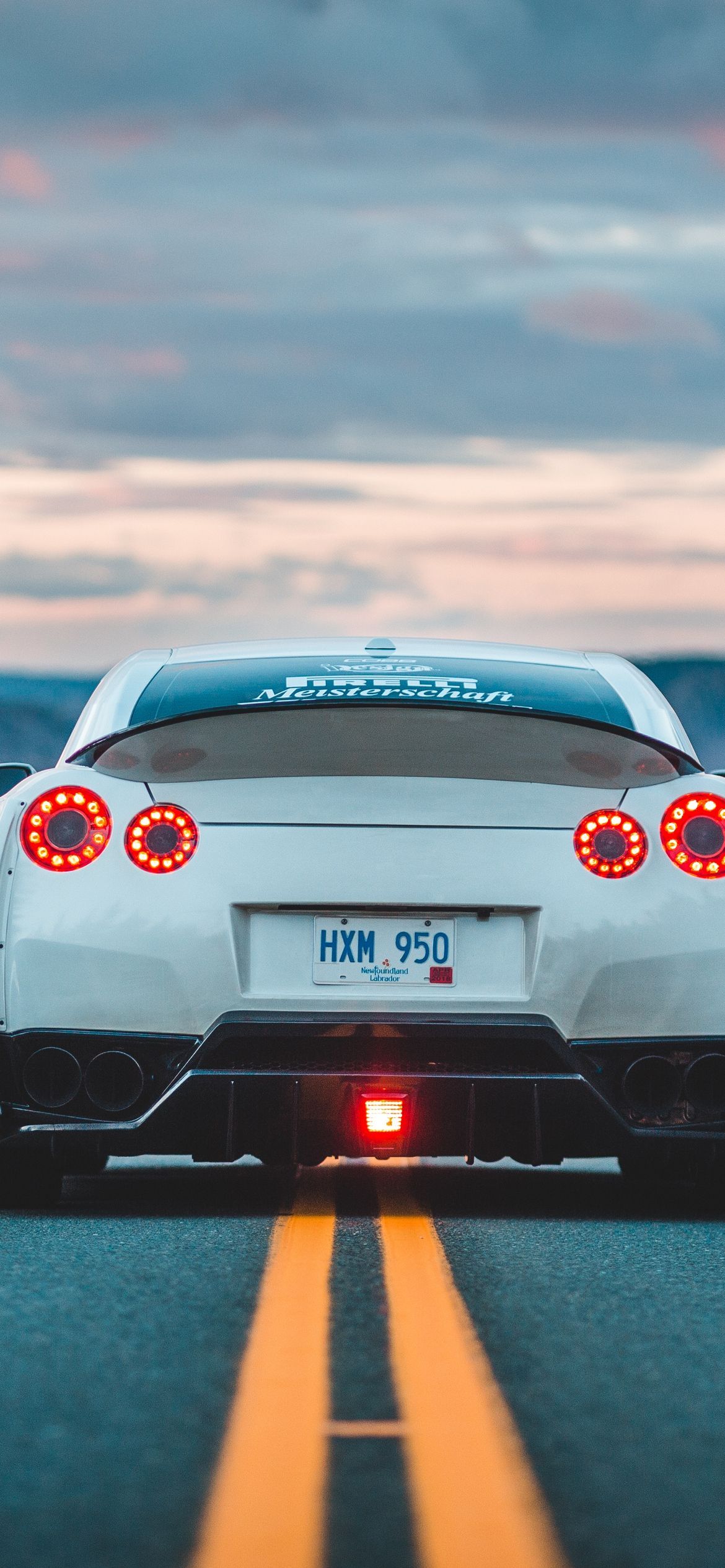 Picture of a white sports car on a road - Nissan Skyline