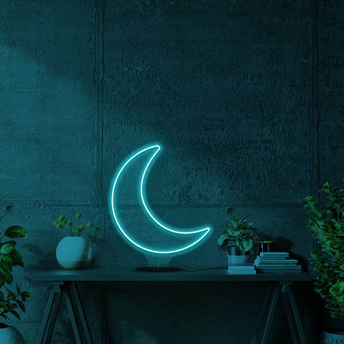 A moon neon sign on a table in a dark room - Aqua