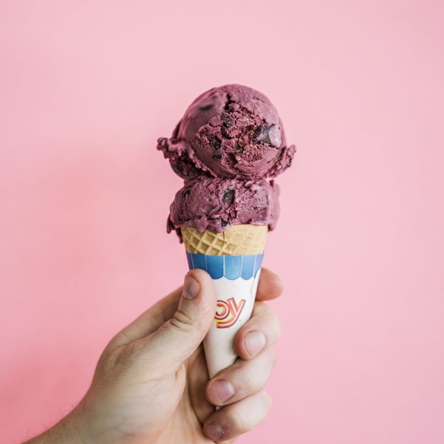 A person holding an ice cream cone in their hand - Ice cream