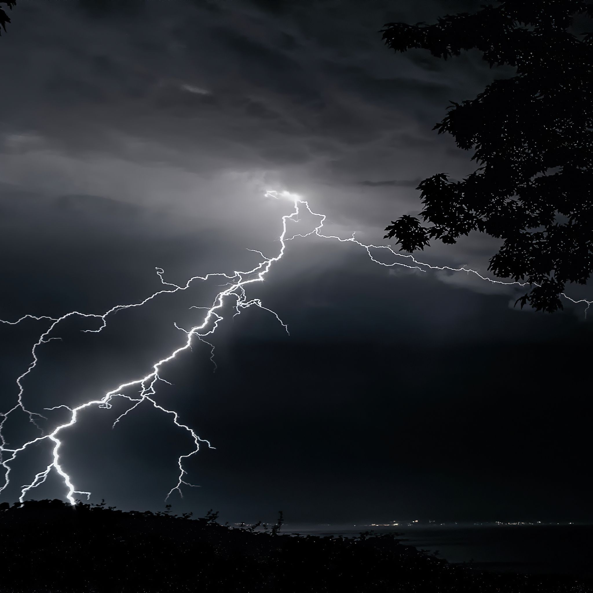 A lightning storm over a lake at night - Lightning
