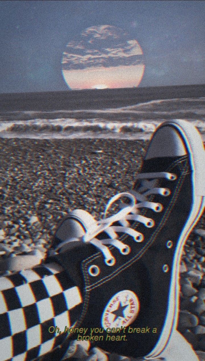 Aesthetic background of a pair of converse sneakers on a beach - Converse