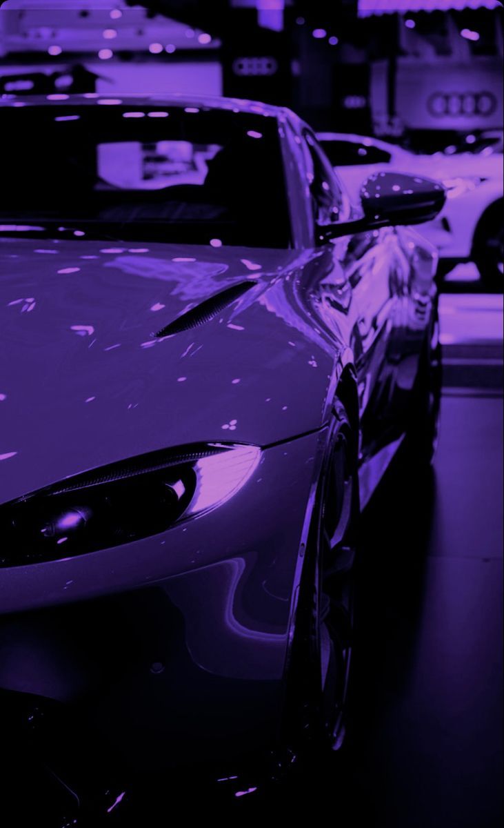 A purple car is parked in a garage. - Cars