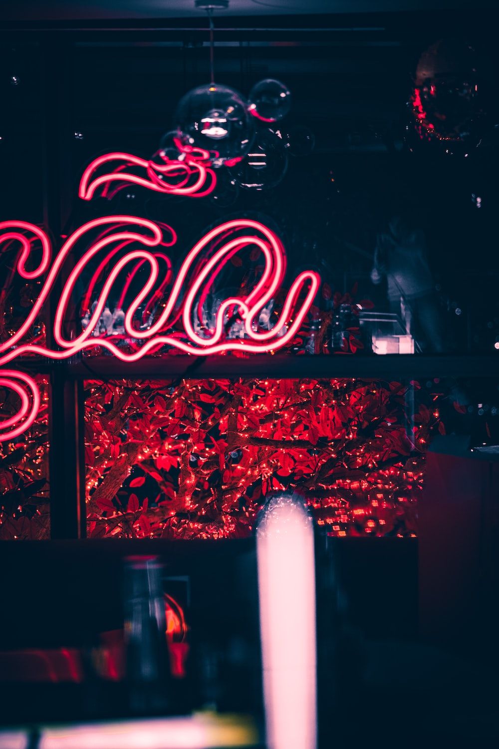 A neon sign in a dark room with red lights photo