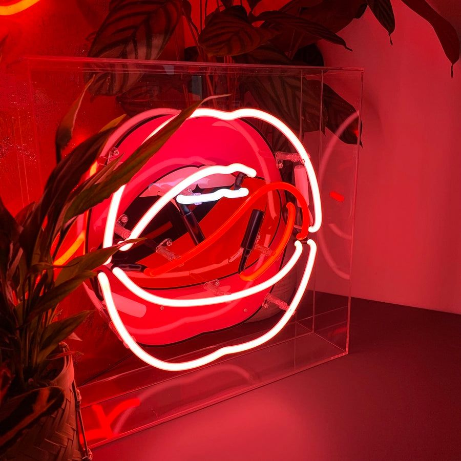 A neon sign of a pair of lips in red neon. - Neon red