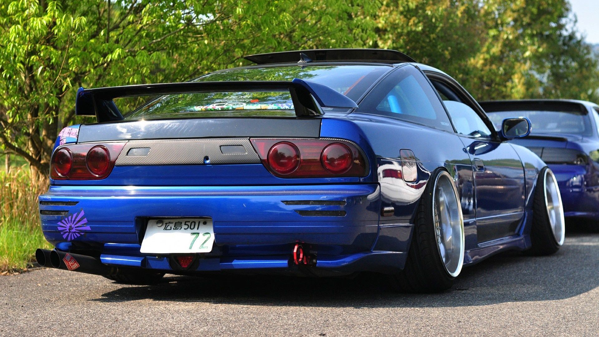 Blue Nissan 240SX with a big wing and custom plate - JDM