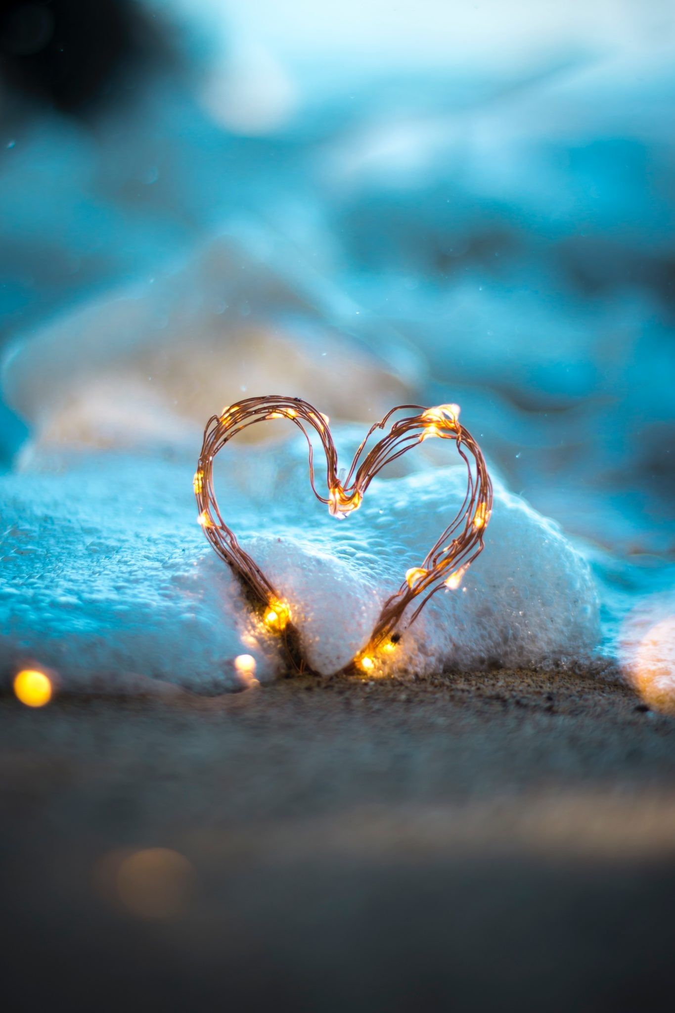 A heart made of string lights on a blanket of snow - Heart