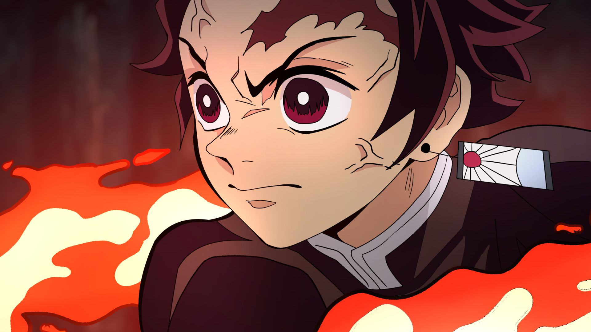 A close-up of a young man with short hair and a black shirt, with a red and orange flame behind him. He has a determined look on his face. - Tanjiro Kamado