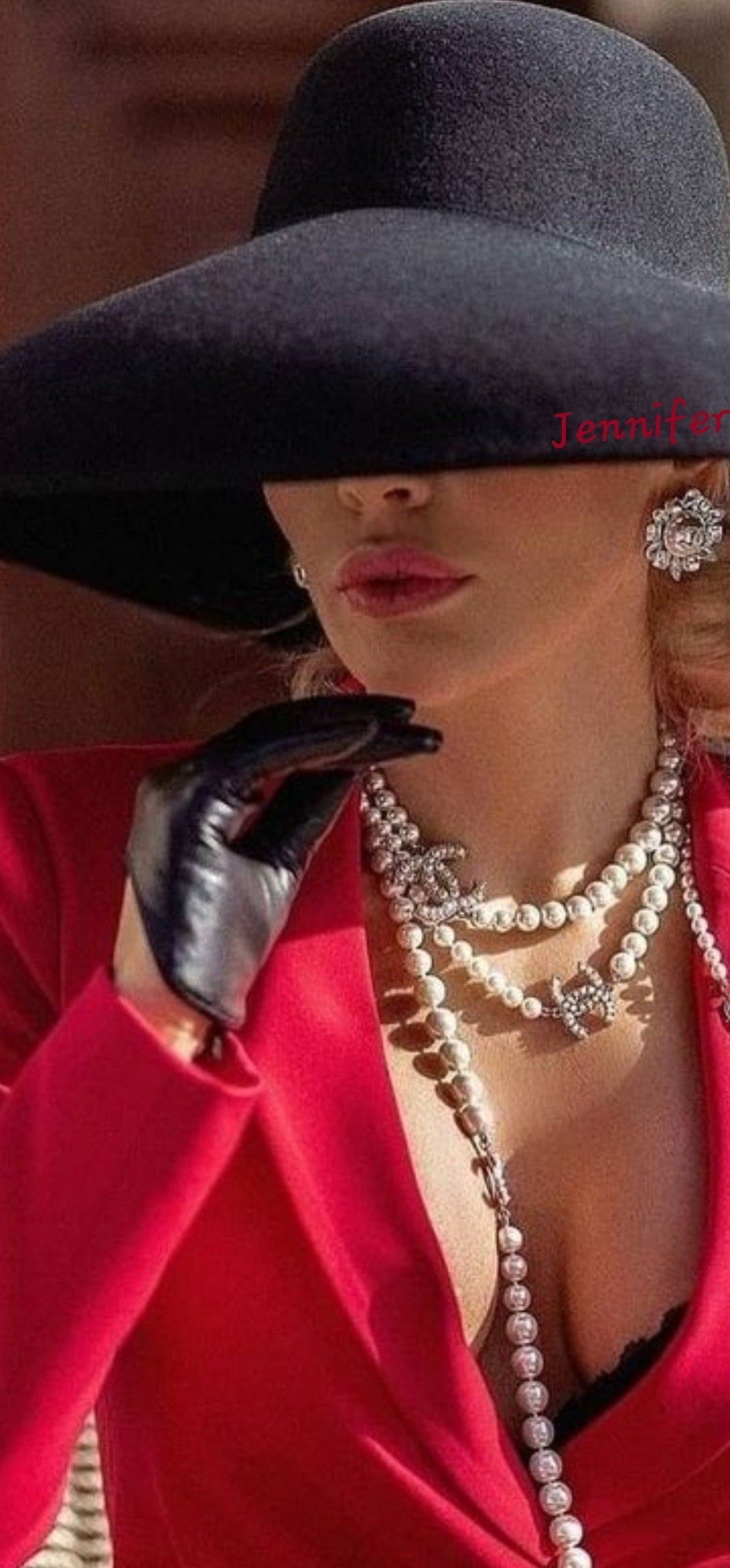 Jennifer Lopez wearing a black hat, red top, pearls and black gloves - Money