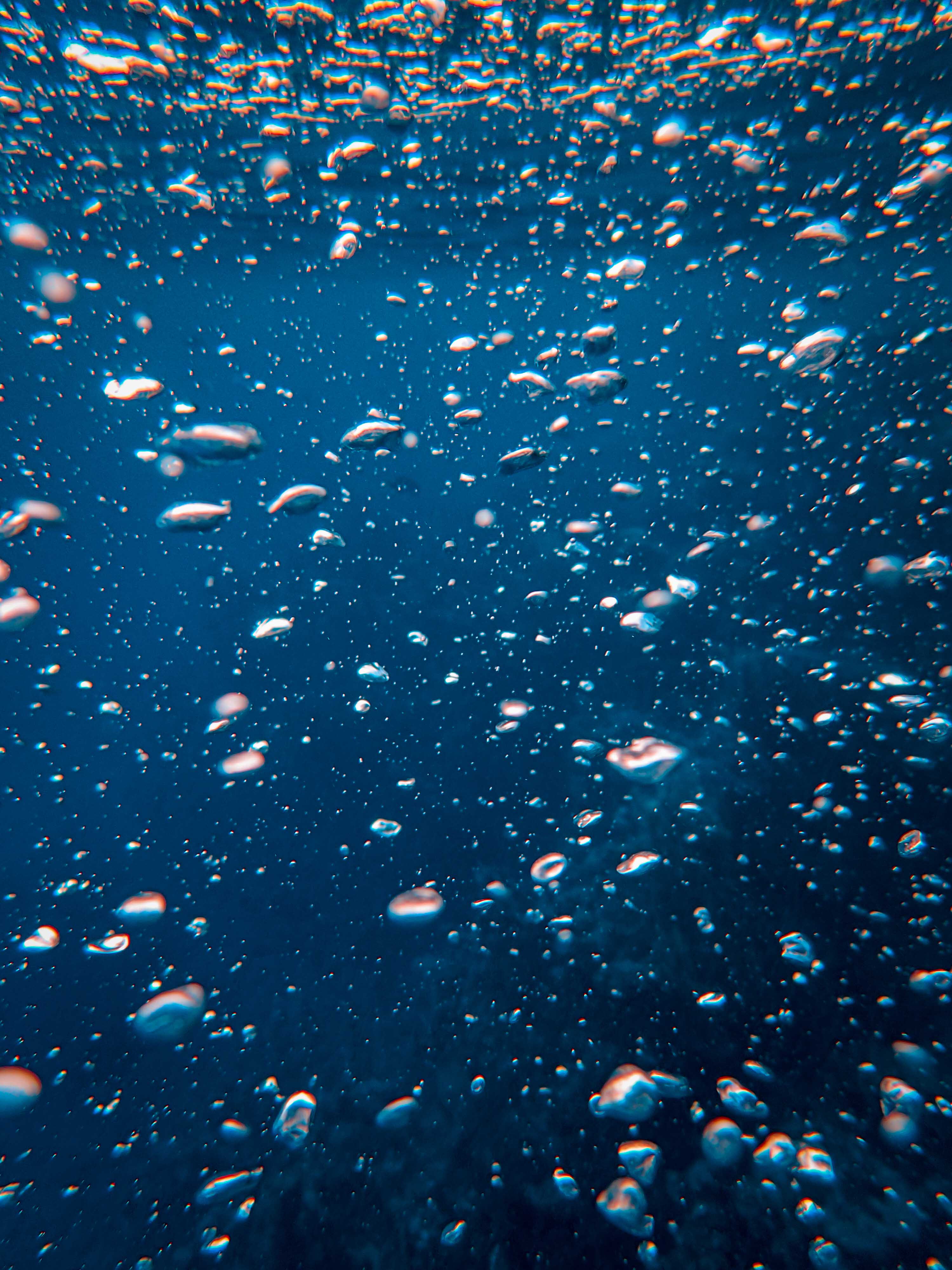 Underwater shot of air bubbles in a blue sea - Underwater