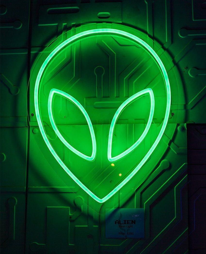 A neon sign of an alien's face on a green background. - Neon green