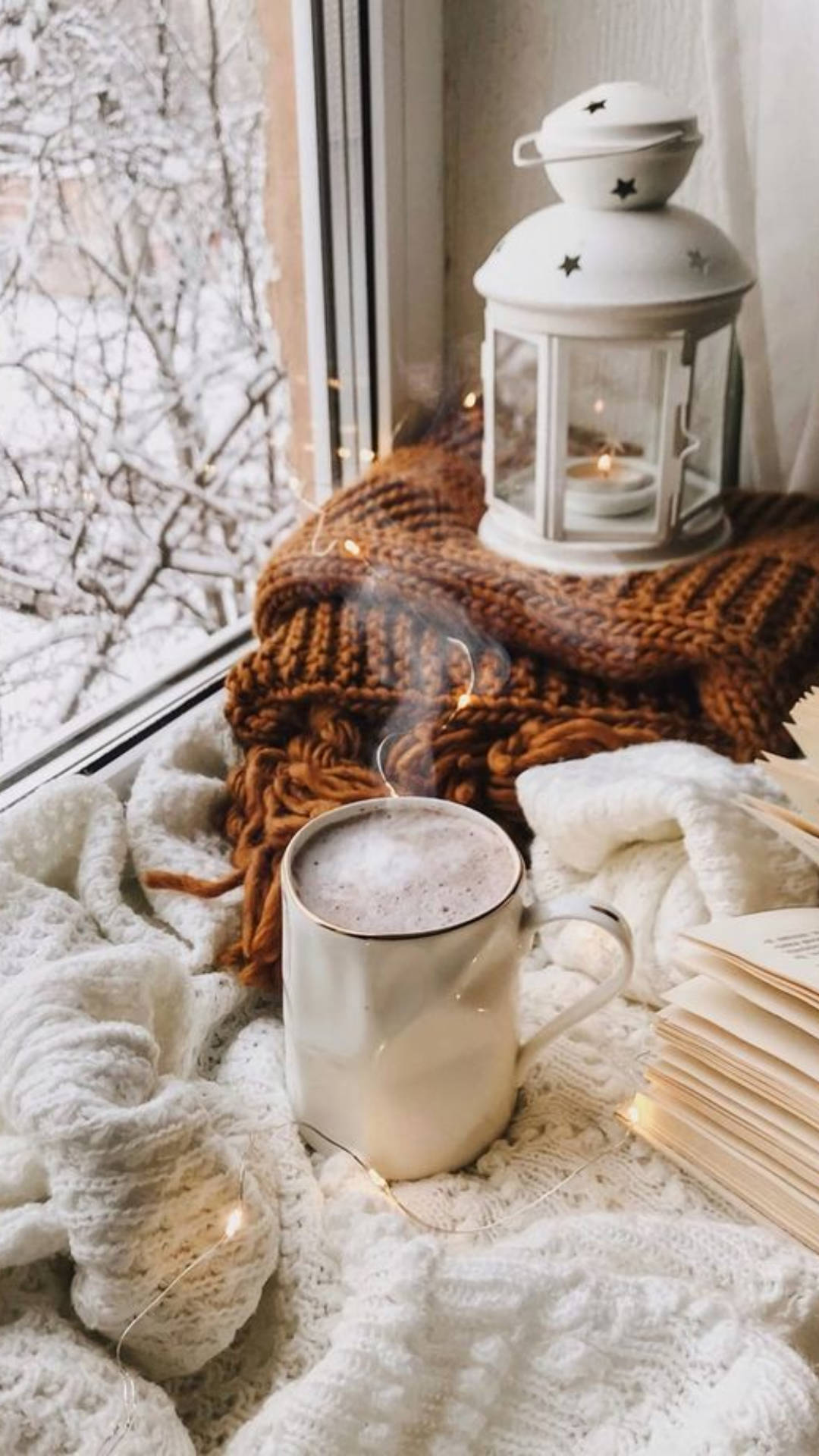 A cozy winter scene with a cup of hot chocolate, a book, and a window. - Cozy