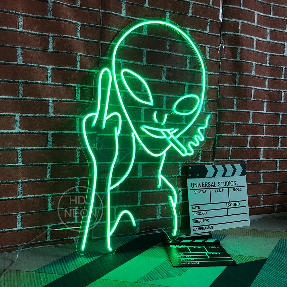 A neon sign of an alien with a middle finger - Neon green